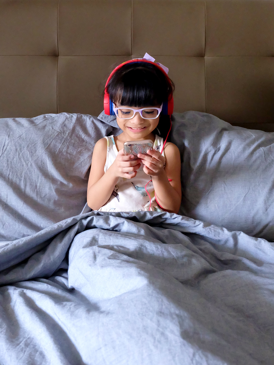 Zoë, enjoying her new JBL JR300 headphones in Spider Red