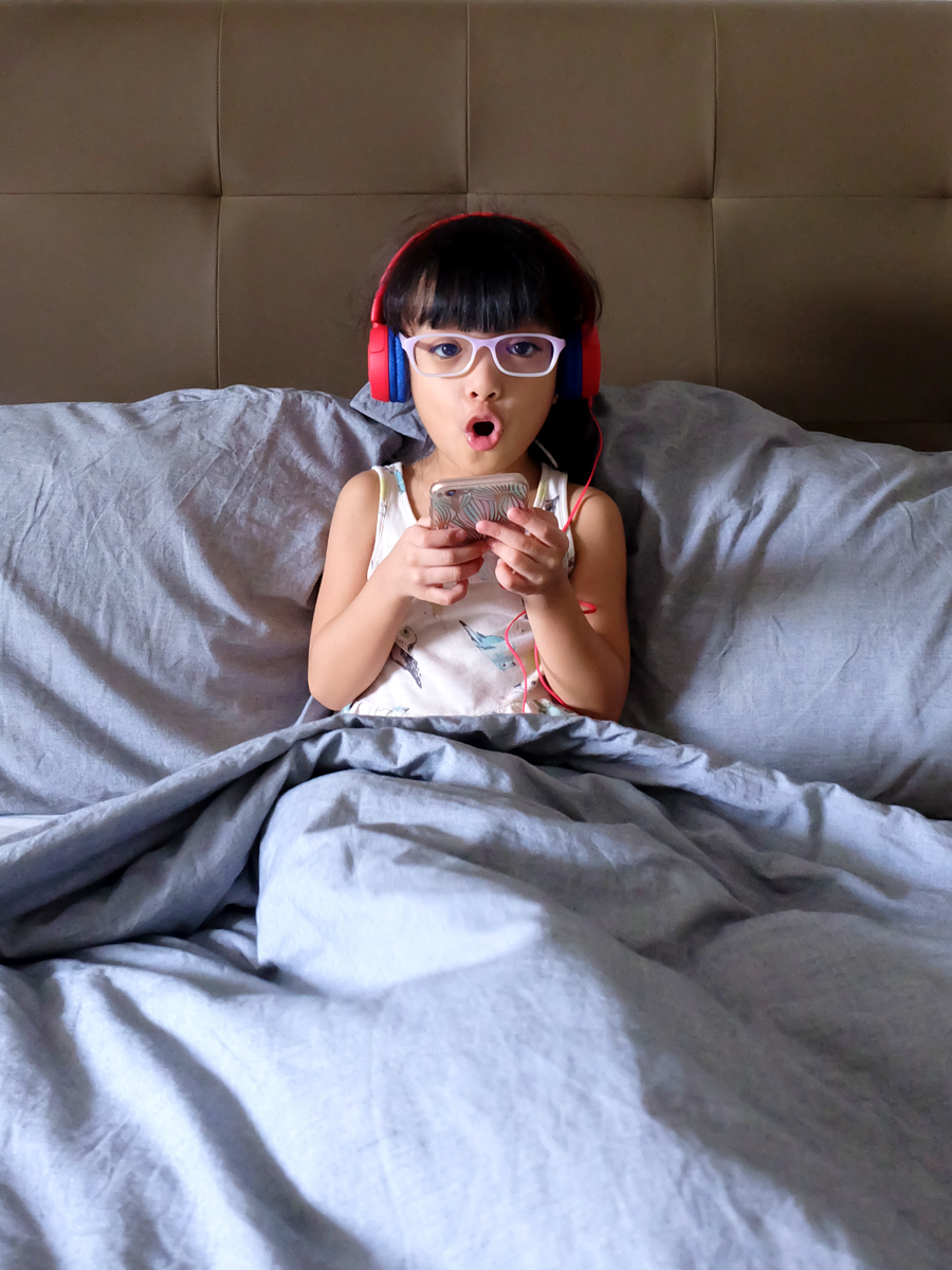 Zoë, enjoying her new JBL JR300 headphones in Spider Red