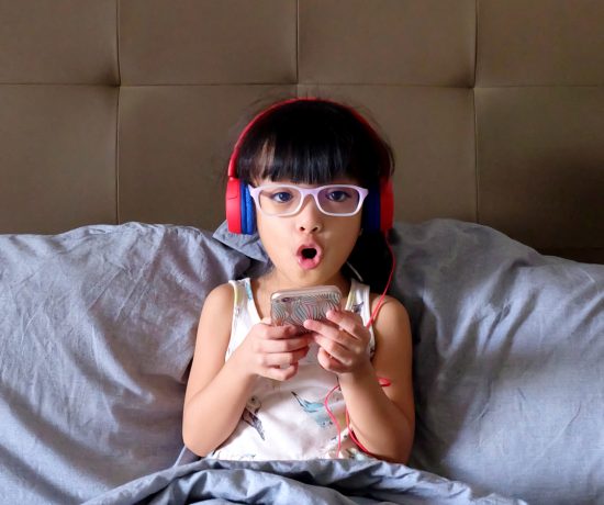 Zoë, enjoying her new JBL JR300 in Spider Red